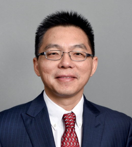 Clean cut Asian man with glasses and a suit and tie